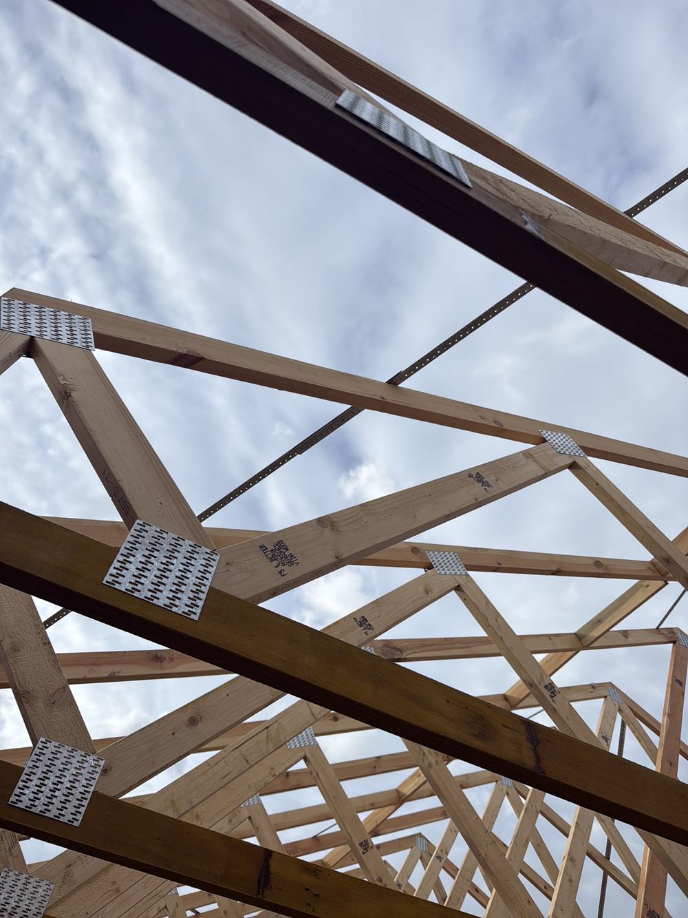 Roof metal brace spliced without being bent over and nailed to the chord, found during a frame inspection in Pakenham