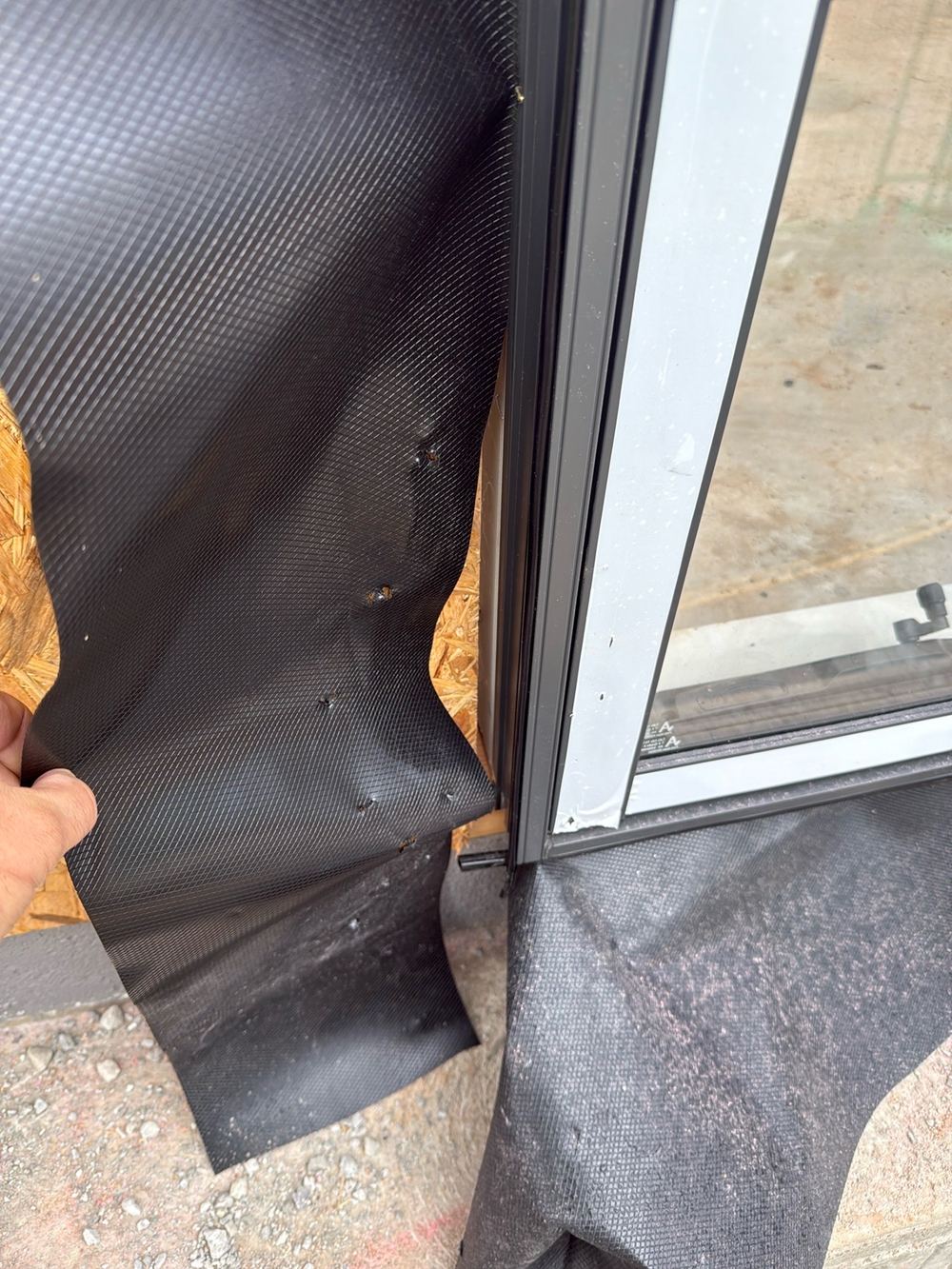 Window side flashing torn at the base of the opening, found during a frame inspection in Pakenham