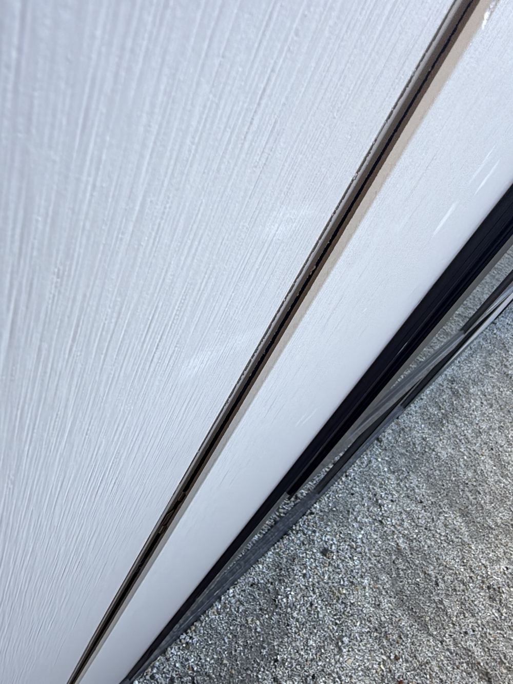 Cladding boards not fully interlocked, leaving uneven gaps along the joint, found during a pre-handover inspection in Pakenham