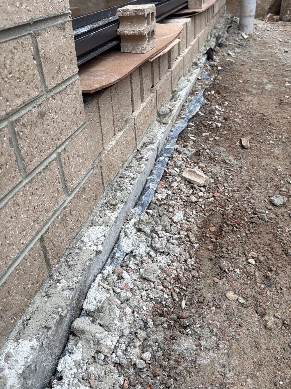 Slab edge projecting past the brickwork and needing to be trimmed flush, found during a lock-up inspection in Pakenham