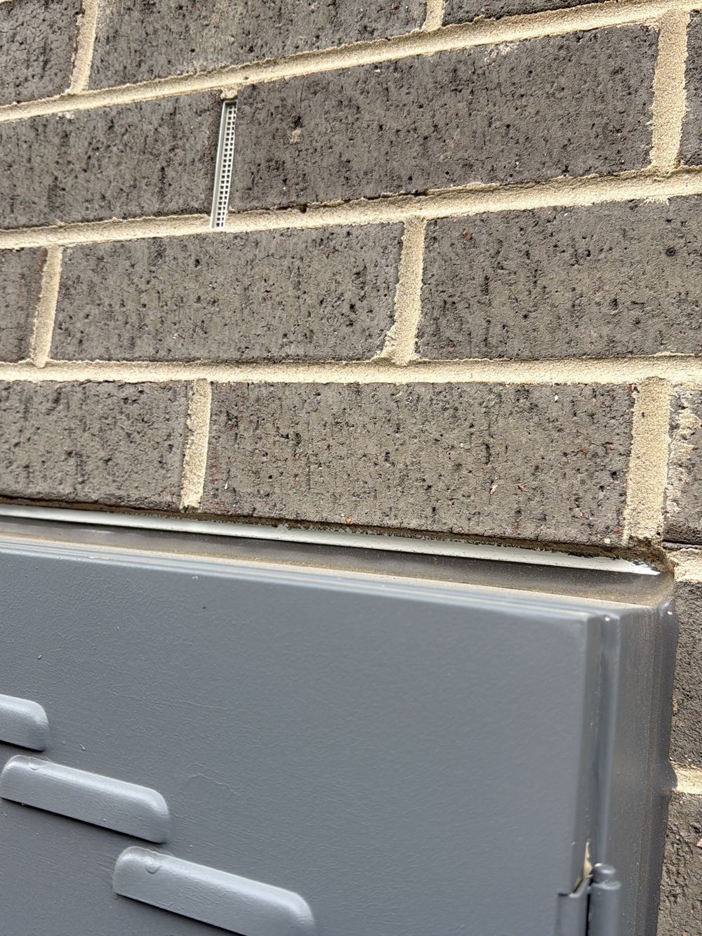 Gap around the meter box with the timber frame visible behind it, found during a pre-handover inspection in Pakenham