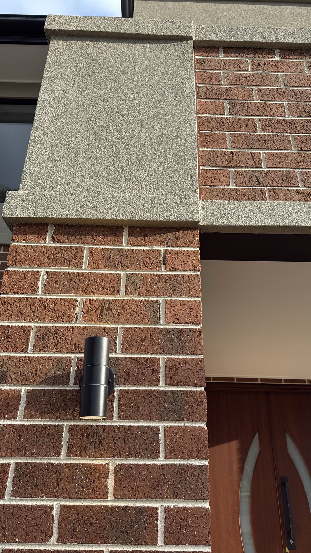 Voids left in the mortar joints of a feature brick pier at the entry, Pakenham