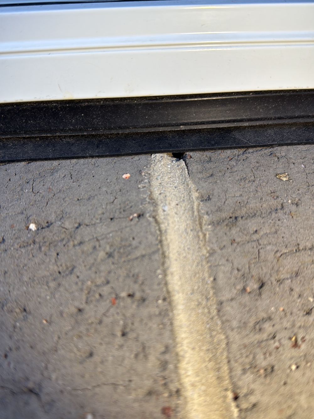 Gaps in the mortar under a window sill