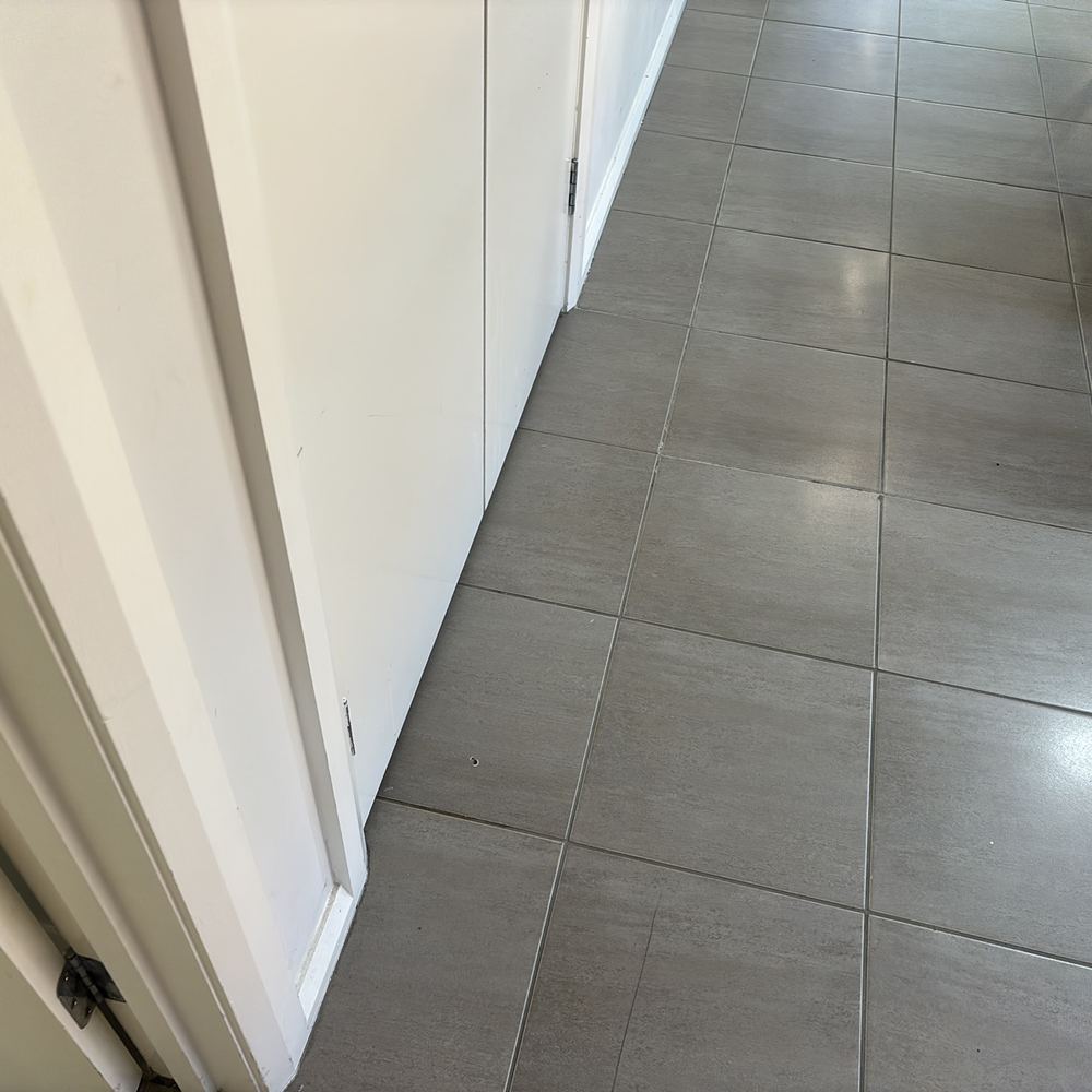 Damaged floor tile at a hallway doorway that will keep cracking if left, found during a pre-purchase inspection in Pakenham