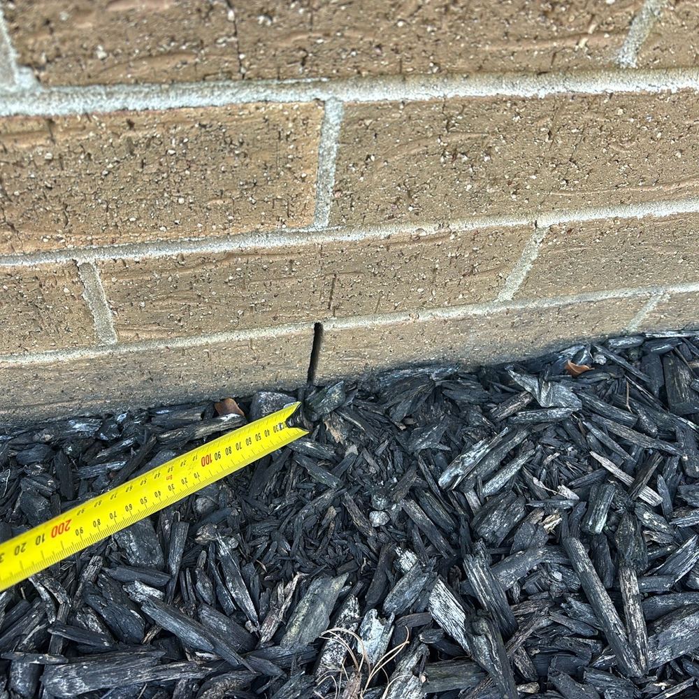 Weep holes sitting almost at garden level, inviting damp and termites into the cavity, found during a pre-purchase inspection in Pakenham